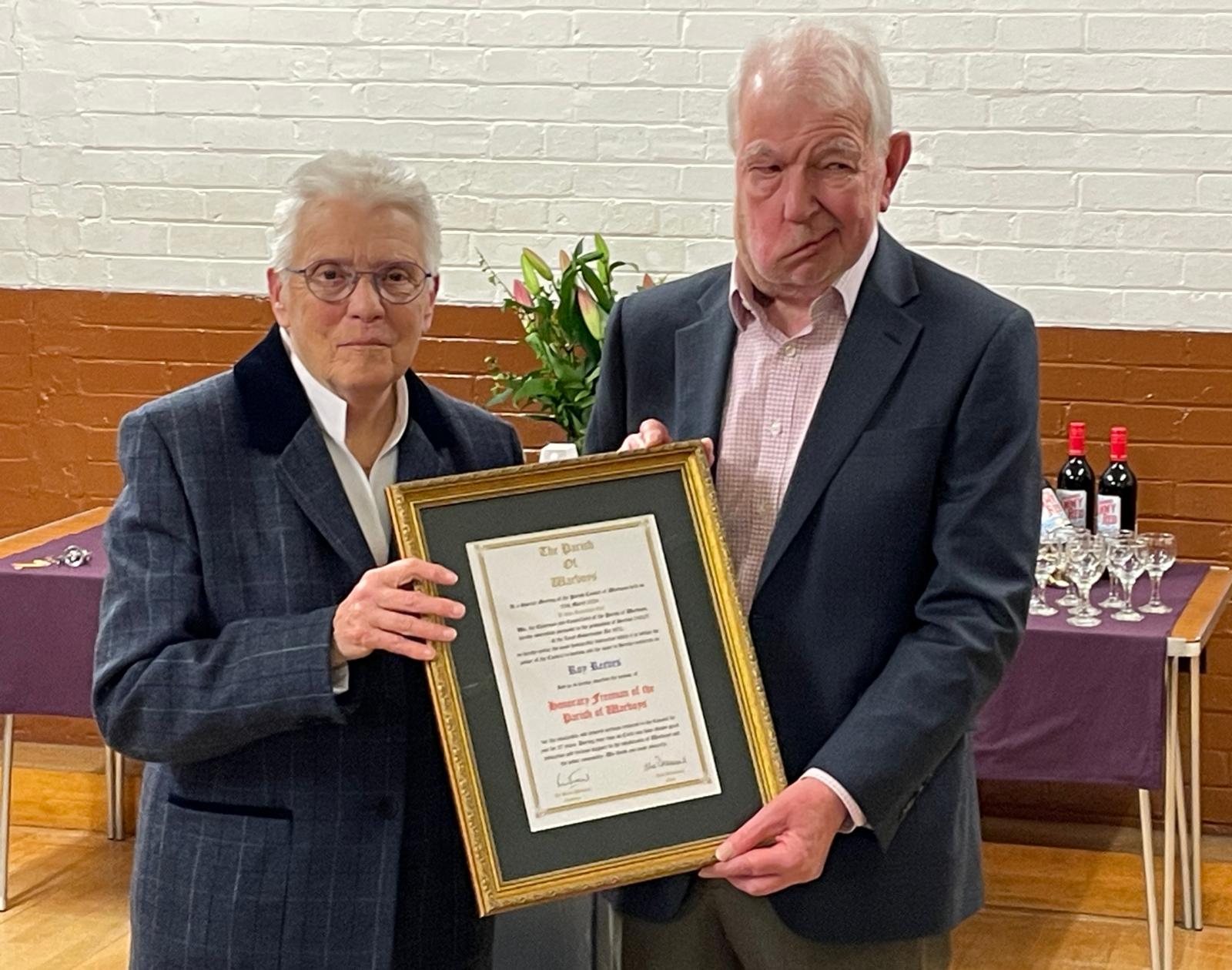 Chair Withams hands R Reeves his scroll as Freeman of Warboys